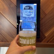 a person holding a glass of beer