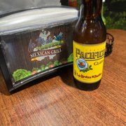 a bottle of beer next to a cooler
