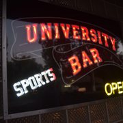 a neon sign on a brick wall