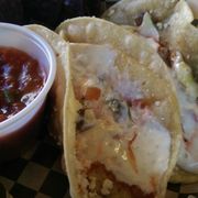 a plate of tacos and salsa