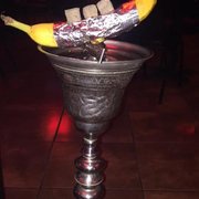 a banana in a silver bowl