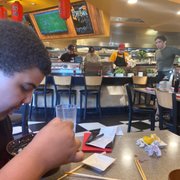 a boy eating at a restaurant