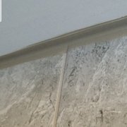 bad caulking job at tile/ceiling joint in all showers