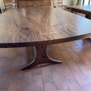 Love this table. Black walnut. They do have a good collection of slabs. Glad they're being efficient. With the wood from trimming and fires.