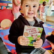 Look at that focus!! We love to see our kids reading books and being read too!
