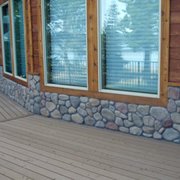 a view of a porch with a stone wall
