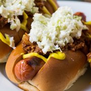 two hot dogs with coleslaw and mustard