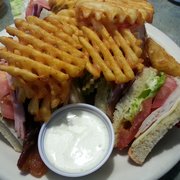 Club sandwich on wheat with seasoned fries and ranch.