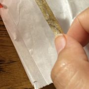 a hand holding a piece of food