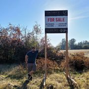Austin putting up a sign for a listing.