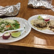 Two beef tacos with cheese and a tostada