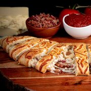 a wooden cutting board with a variety of foods