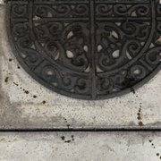 a round iron grate on the side of a building