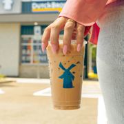 a hand holding a cup of iced coffee