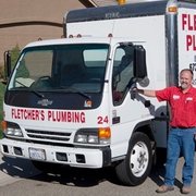 a man standing next to a truck