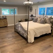 This master bedroom has a cozy yet cool and stylish feel to it! We installed hardwood floor for a sleek but home-y look.