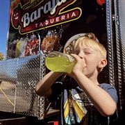 a young boy drinking a drink