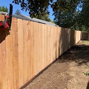 a wood fence with a chain link
