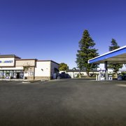 a gas station with a blue sky in the background