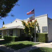 an american flag flying in front of a building