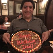 a man holding a birthday cake
