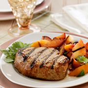 a plate of grilled steak with peaches
