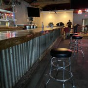 a bar with stools at the bar