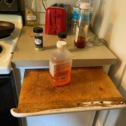 Disgusting kitchen and cutting board.