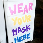 a sign that says wear your mask here