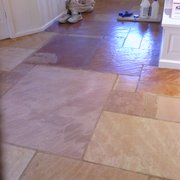 This photo is of a stone floor before/after. We removed many years of floor polish to reveal the natural color of the stone.