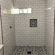 a shower with a tiled floor