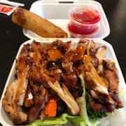 Chicken bowl with 1 imperial roll and two sides of sweet & sour.