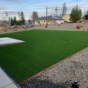 a backyard with artificial grass