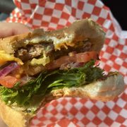 a person holding a sandwich in their hand