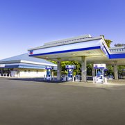 a gas station with blue and white paint
