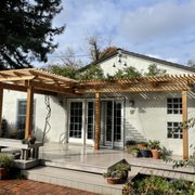 a patio with a pergolated roof