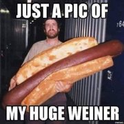 a man holding a giant hot dog