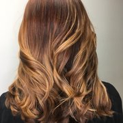 A very subtle balayage with warm reddish brown roots and golden peaks of light!