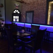 a dimly lit dining room with bar stools