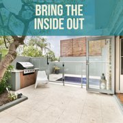 a patio with patio furniture and a tree