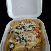 Chicken Nachos. Cheap store bought chips, but huge amounts of food and meat for a low low price which completely makes up for it