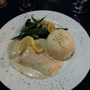 Broiled salmon fillet with rice pilaf.