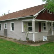 a gray house with a brown roof