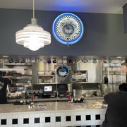 This is the service counter with the coffee cups for all the regulars