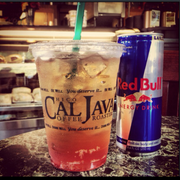 a cold beverage and a can of red bull