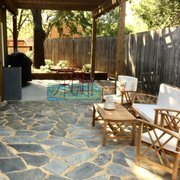 a patio with chairs and a table