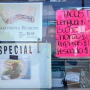 menus and prices in a store window