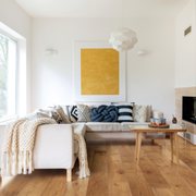 a white living room with wood floors
