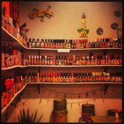 a shelf full of chili sauces