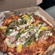Red sauce, mozzarella, Canadian bacon, pineapple, and mushrooms with pesto drizzle